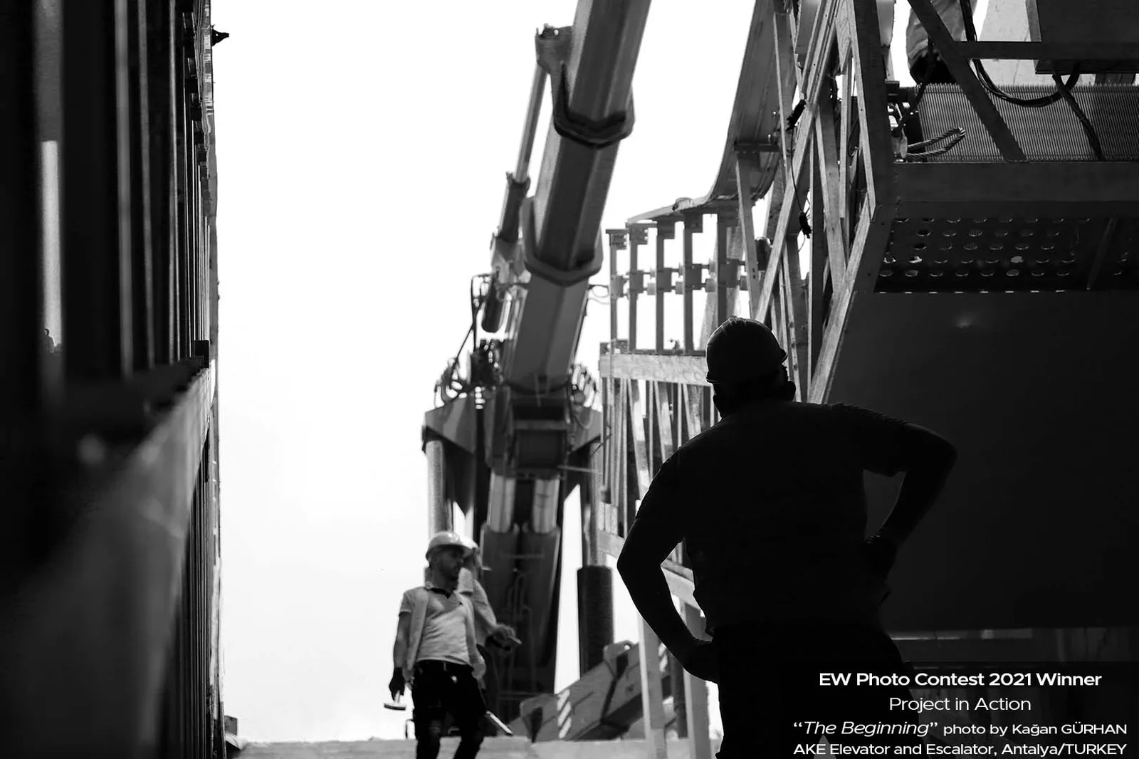 Black-and-white photograph of a technician in a lift shaft