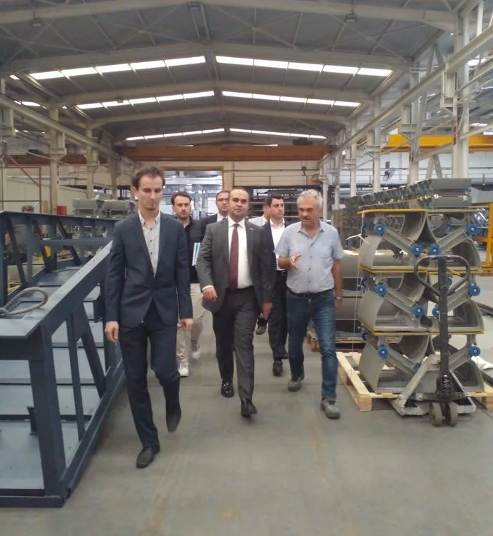 Visitors touring the AKE production area