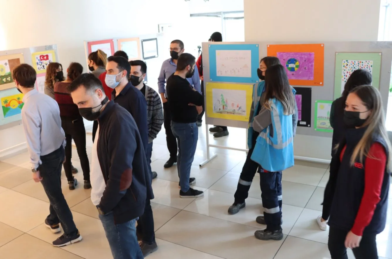 Children and adults at the art exhibition